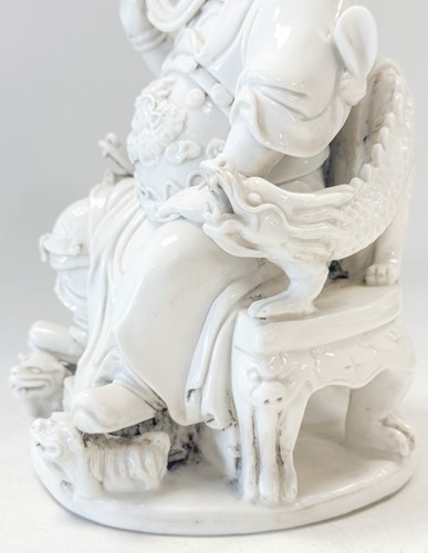 Lot 48 - A Dehua seated figure of Guandi, Daoist God of War, mark of He Chaozong