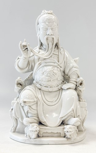 Lot 48 - A Dehua seated figure of Guandi, Daoist God of War, mark of He Chaozong