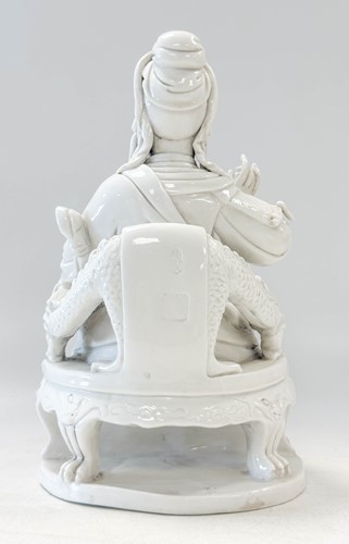Lot 48 - A Dehua seated figure of Guandi, Daoist God of War, mark of He Chaozong
