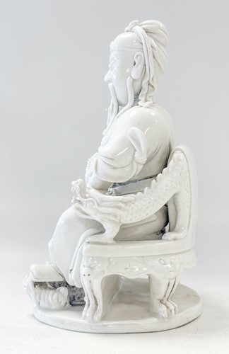 Lot 48 - A Dehua seated figure of Guandi, Daoist God of War, mark of He Chaozong