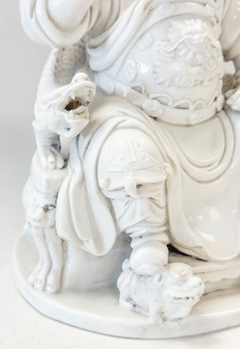 Lot 48 - A Dehua seated figure of Guandi, Daoist God of War, mark of He Chaozong