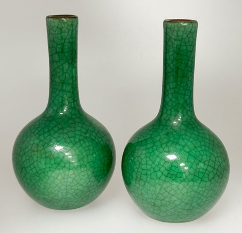 Lot 46 - A pair of Chinese green monochrome small bottle vases, Qing Dynasty, 19th century