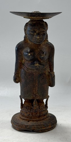 Lot 42 - A Javanese Majapahit period Indonesian bronze and iron figure of a half nude woman, 14th century