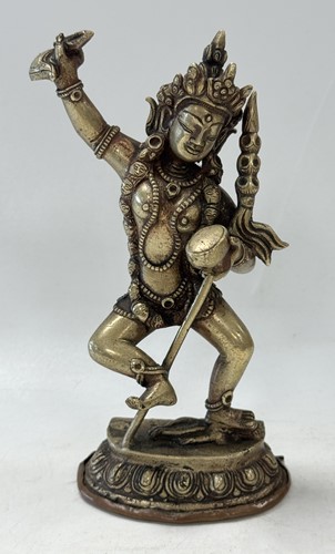 Lot 89 - A Tibetan silvered metal figure of Vajravarahi dancing on a corpse