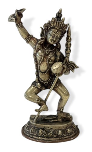 Lot 89 - A Tibetan silvered metal figure of Vajravarahi dancing on a corpse