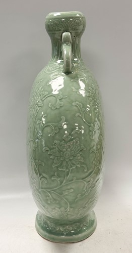 Lot 14 - A Chinese celadon glazed and carved large moonflask, Qing Dynasty, 18th century