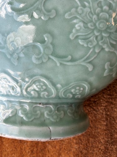 Lot 14 - A Chinese celadon glazed and carved large moonflask, Qing Dynasty, 18th century