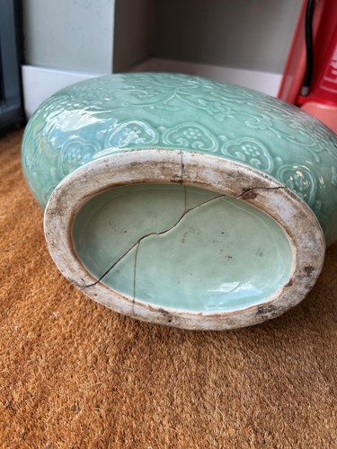 Lot 14 - A Chinese celadon glazed and carved large moonflask, Qing Dynasty, 18th century