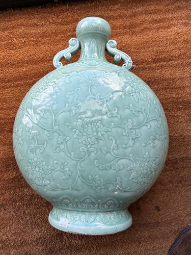 Lot 14 - A Chinese celadon glazed and carved large moonflask, Qing Dynasty, 18th century