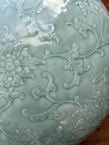 Lot 14 - A Chinese celadon glazed and carved large moonflask, Qing Dynasty, 18th century