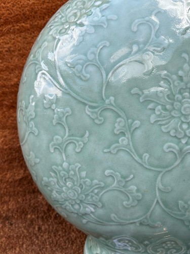 Lot 14 - A Chinese celadon glazed and carved large moonflask, Qing Dynasty, 18th century