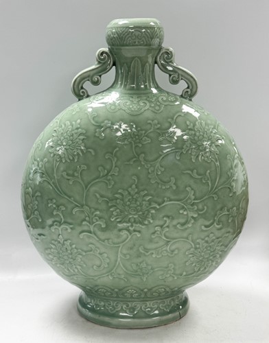 Lot 14 - A Chinese celadon glazed and carved large moonflask, Qing Dynasty, 18th century