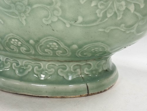 Lot 14 - A Chinese celadon glazed and carved large moonflask, Qing Dynasty, 18th century