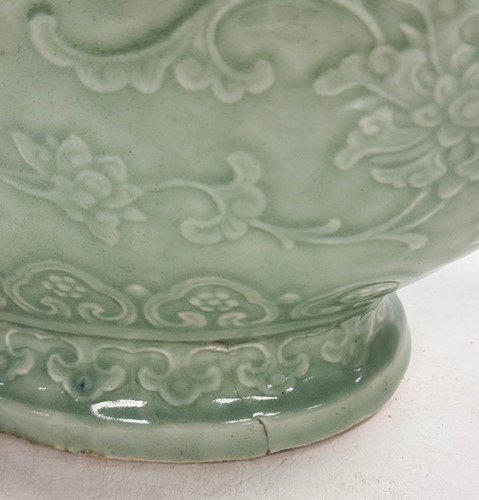 Lot 14 - A Chinese celadon glazed and carved large moonflask, Qing Dynasty, 18th century