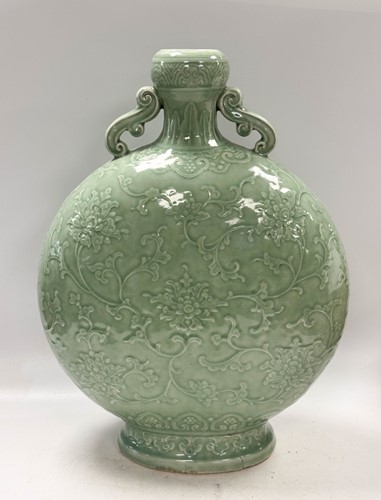 Lot 14 - A Chinese celadon glazed and carved large moonflask, Qing Dynasty, 18th century