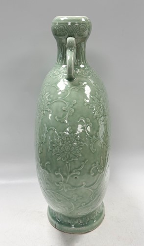 Lot 14 - A Chinese celadon glazed and carved large moonflask, Qing Dynasty, 18th century