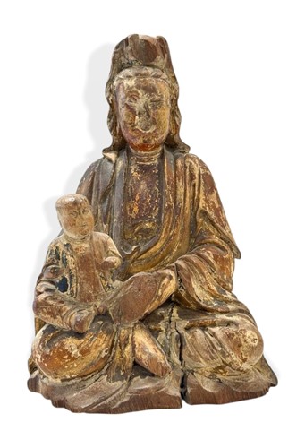 Lot 70 - A Chinese carved and gilded wood figure of Guanyin with child, late Ming/early Qing Dynasty