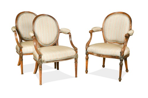 Lot 488 - A pair of George III beech framed fauteuil in the Sheraton manner