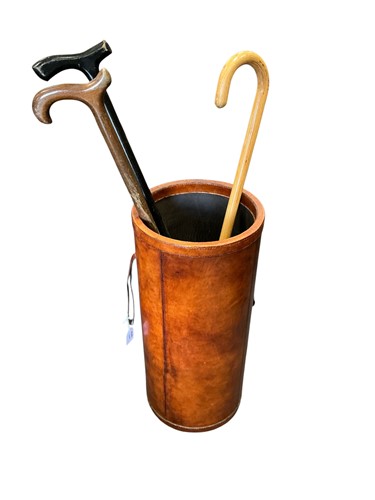 Lot 536 - A brown leather bound stick stand, cylindrical...