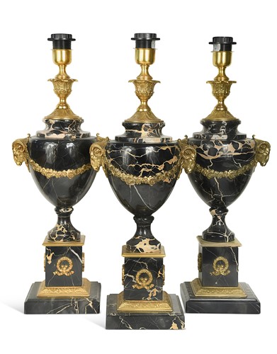 Lot 530 - Three Louis XV style gilt metal mounted black marble table lamps, 20th century