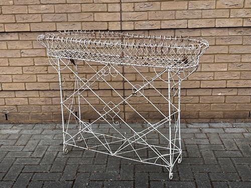 Lot 687 - A 20th century French white painted wirework...