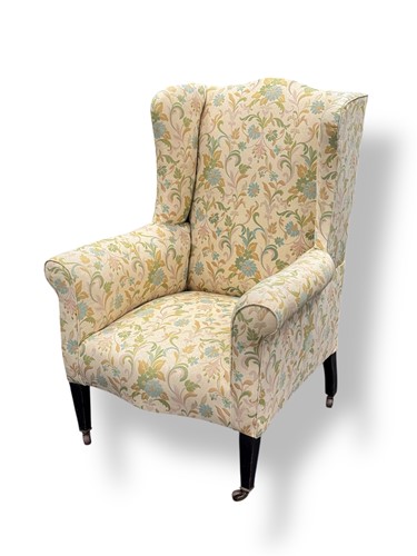Lot 571 - An Edwardian wing back armchair, floral...