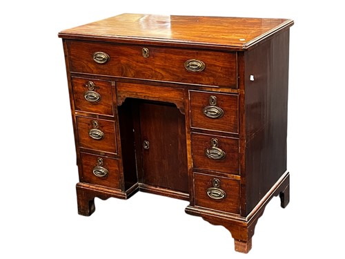 Lot 608 - A George III mahogany kneehole desk, with...