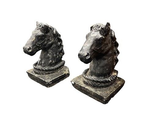 Lot 693 - A pair of black painted composite stone horse...