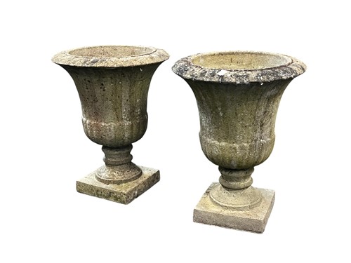 Lot 685 - A pair of composite stone garden urns of...