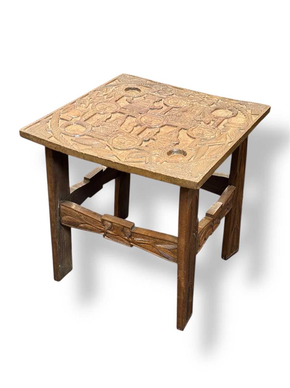 Lot 616 - A 20th century Benin African carved wood table,...