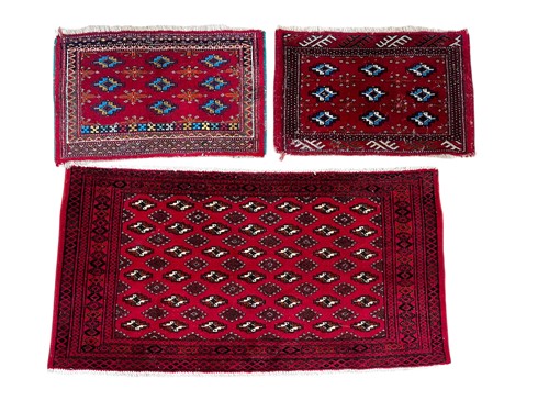 Lot 697 - A Bokhara rug, 115 x 60cm and two Bokhara...