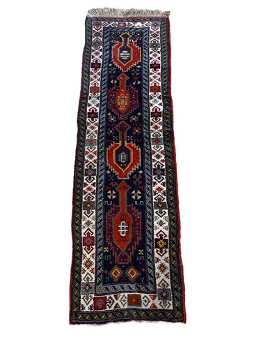 Lot 715 - A Kazak style wool runner, with sage green...