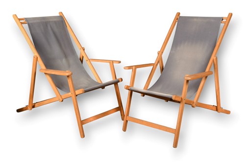 Lot 690 - A pair of contemporary beech framed deck chairs with arms