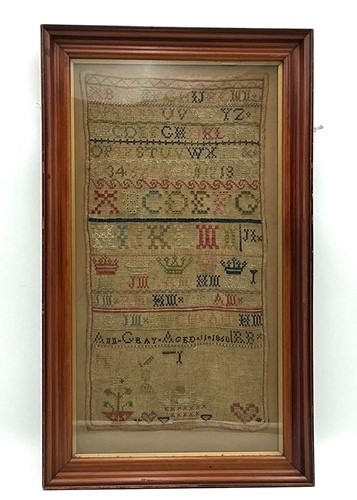 Lot 132 - A framed rectangular needlework sampler - Ann...