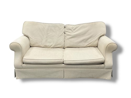Lot 497 - Laura Ashley - A cream upholstered two-seater...