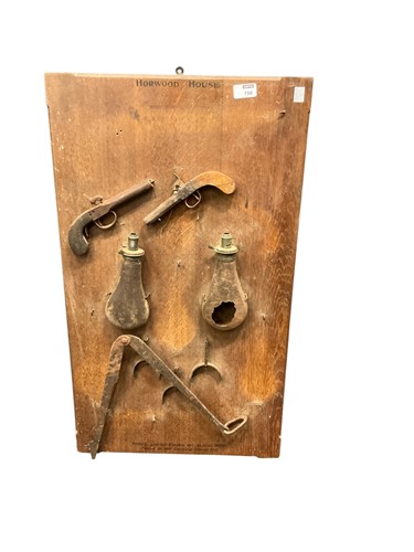 Lot 198 - Mounted powder flasks and pistols, found in...
