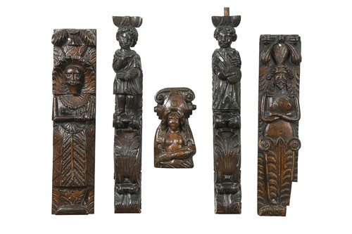 Lot 377 - A collection of five carved oak pew ends
