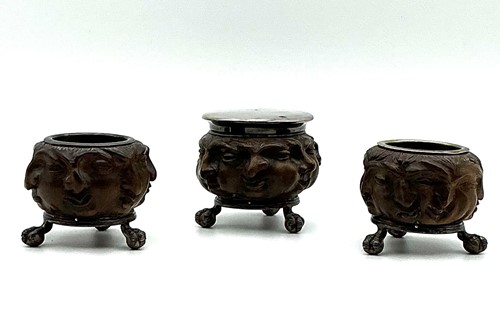 Lot 123 - A three-piece cruet set, each with carved...