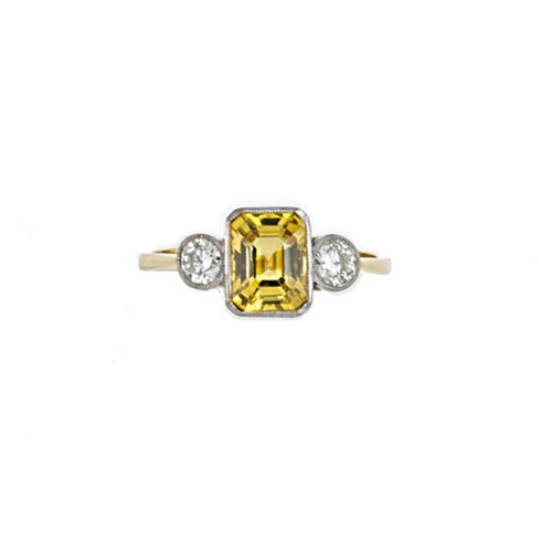 Lot 24 - A yellow sapphire and diamond three stone ring