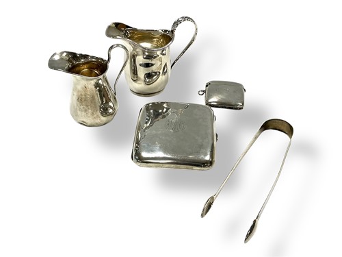 Lot 204 - Two silver cream jugs, a pair of sugar nips,...