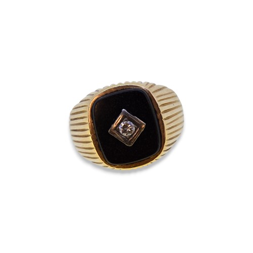 Lot 69 - An onyx and diamond signet ring