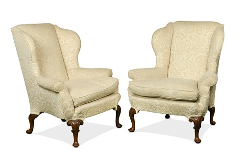 Lot 416 - A pair of George II style walnut wingback armchairs