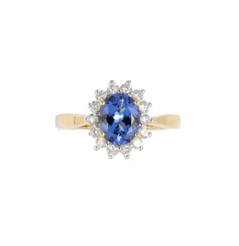 Lot 140 - An 18ct yellow gold tanzanite and diamond cluster ring