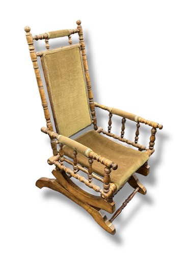 Lot 456 - A green upholstered rocking chair with turned...
