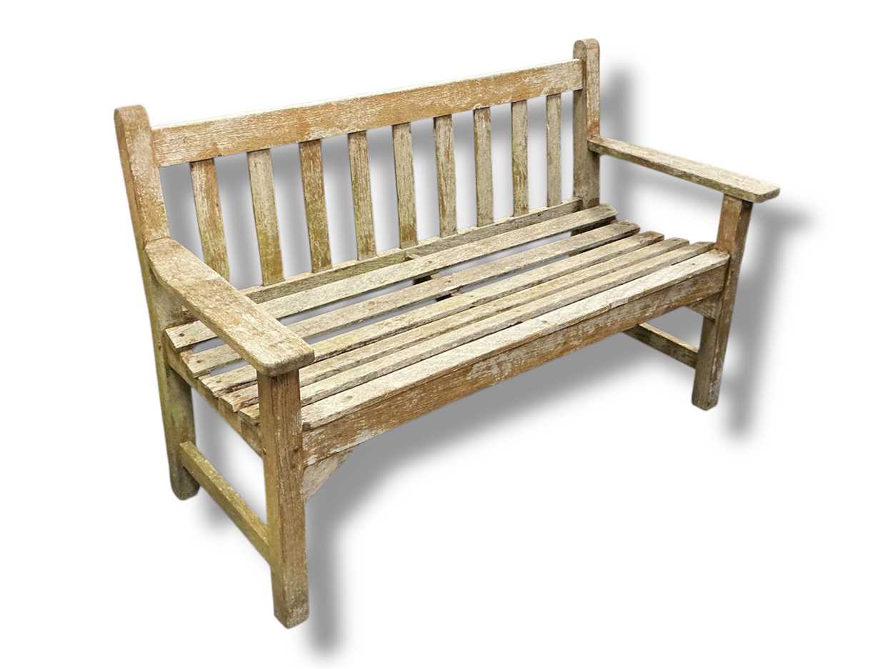Lot 550 - A weathered teak slatted garden bench, 83 x...