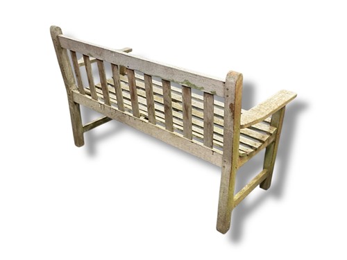 Lot 550 - A weathered teak slatted garden bench, 83 x...