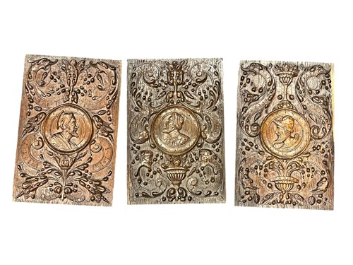Lot 154 - Three carved oak panels, each with portrait...
