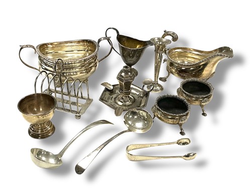 Lot 229 - A collection of silverware including toast...