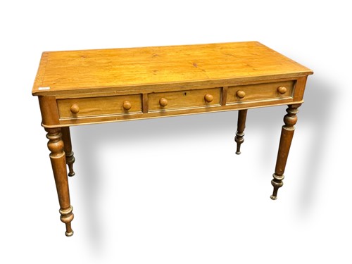 Lot 470 - A pine library table with three frieze drawers...