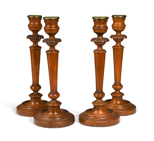 Lot 387 - A set of four carved and turned oak candlesticks, 19th century